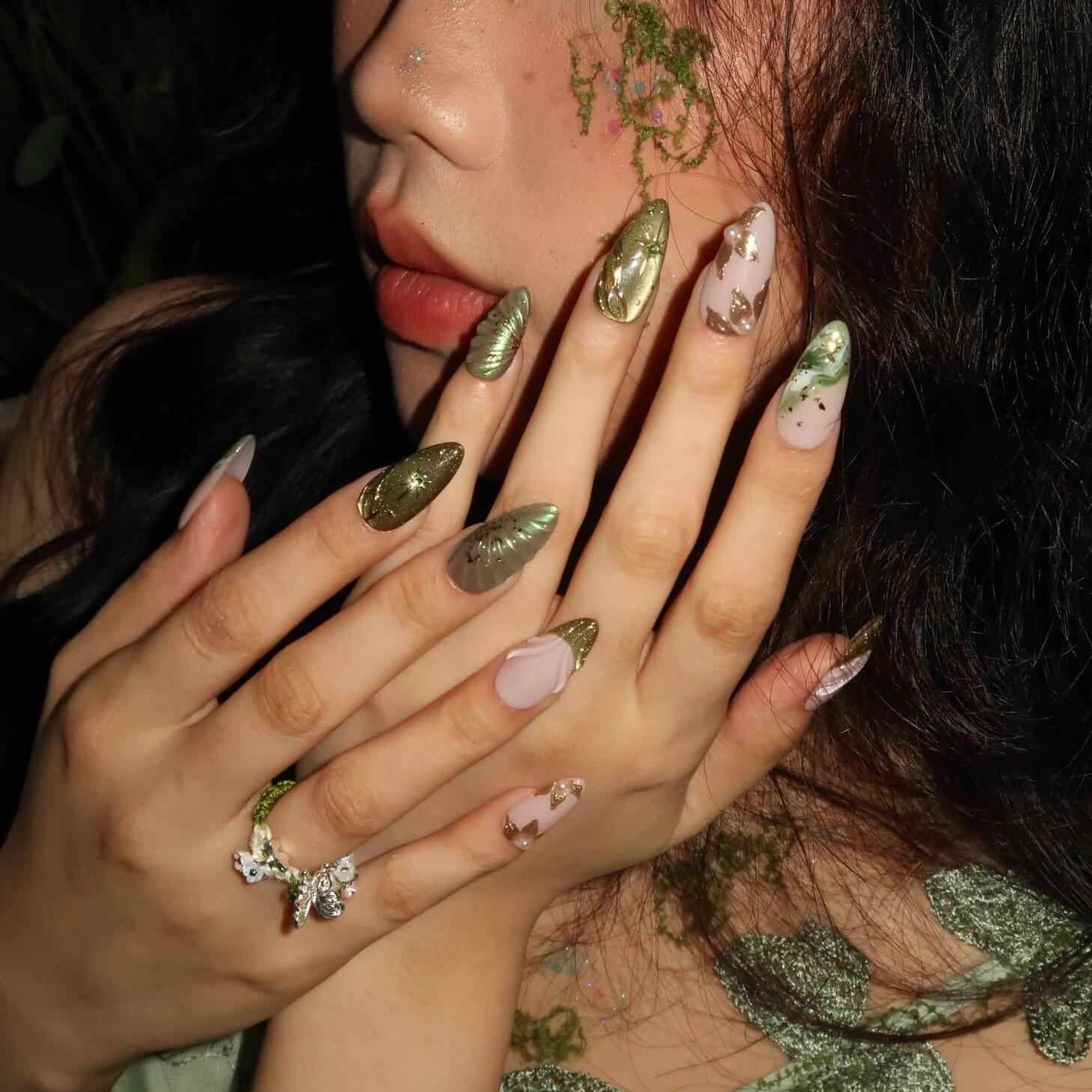 Close-up of a person's hands with decorative nail art.
