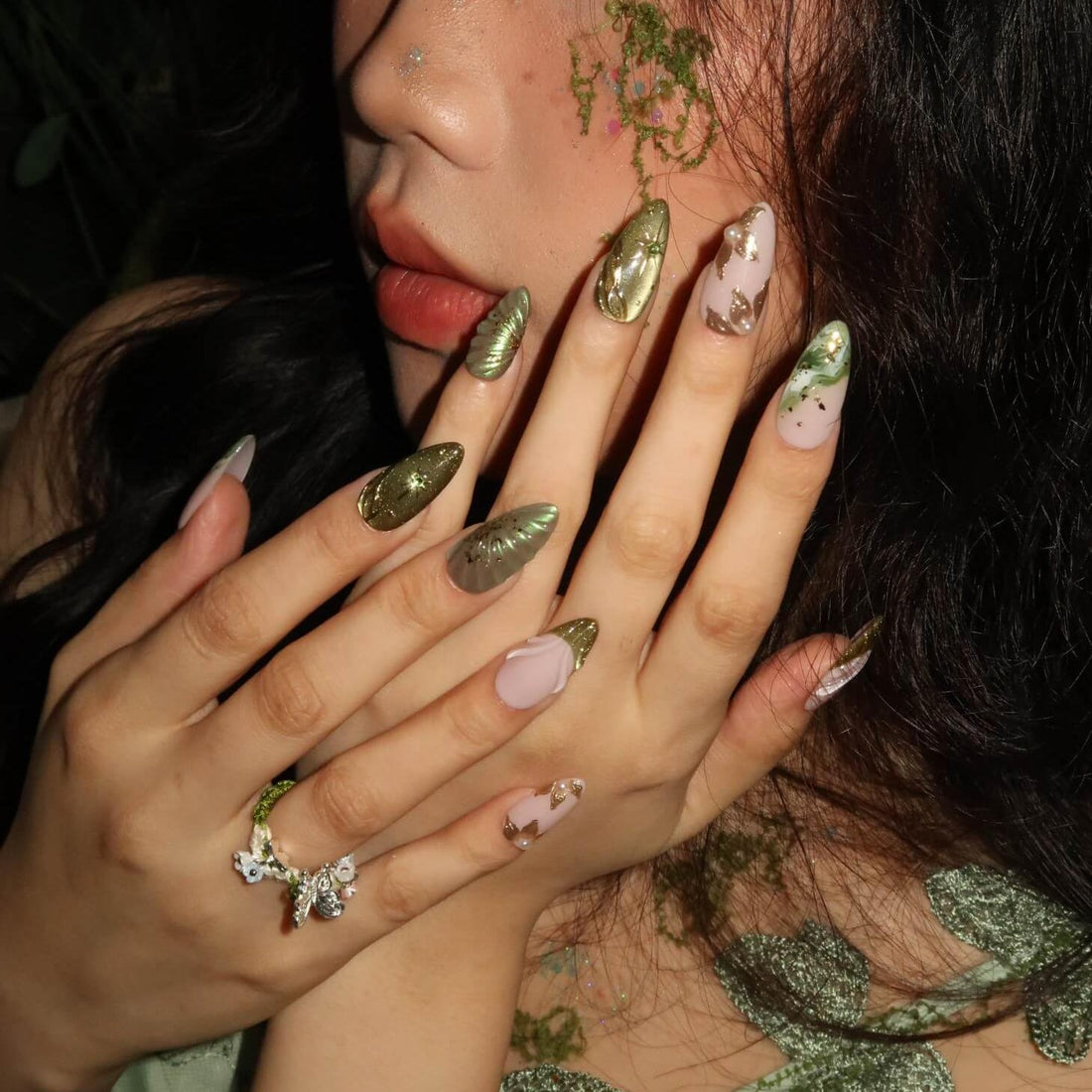 Close-up of a person's hands with decorative nail art.